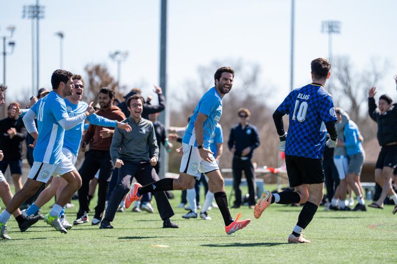 Players sprint onto the field to celebrate a goal